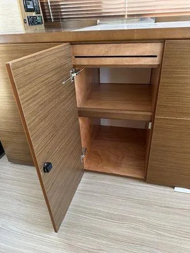 Slide: The Image of 2023 Bavaria R40 Coupe interior cabinet with open wooden door and shelves. - 33