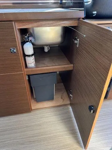 Slide: The Image of 2023 Bavaria R40 Coupe interior cabinet with fire extinguisher and trash bin. - 35
