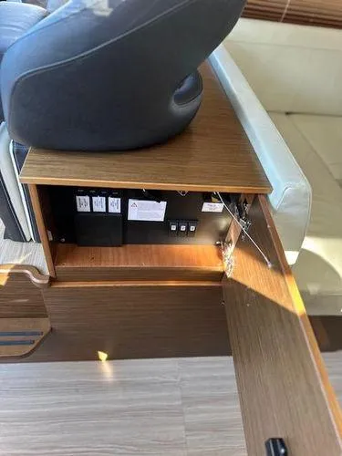 Slide: The Image of 2023 Bavaria R40 Coupe interior, showcasing a wooden storage compartment with electrical components. - 37