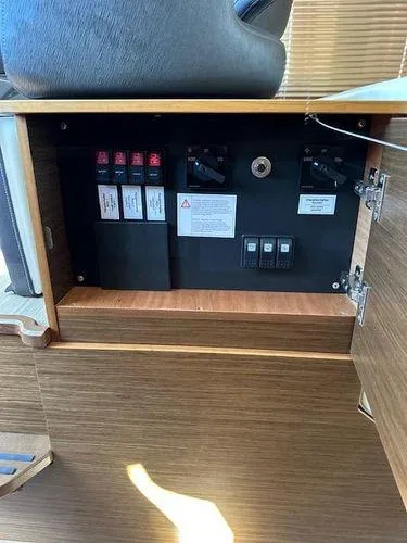 Slide: The Image of Electrical panel inside 2023 Bavaria R40 Coupe yacht, featuring switches and circuit breakers. - 38