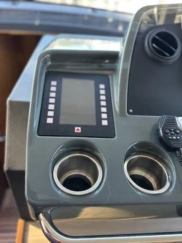 Slide: The Image of Control panel of 2023 Bavaria R40 Coupe with dual cup holders and display screen. - 39