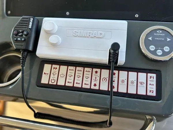 Slide: The Image of Control panel of 2023 Bavaria R40 Coupe with Simrad equipment and various function buttons. - 40