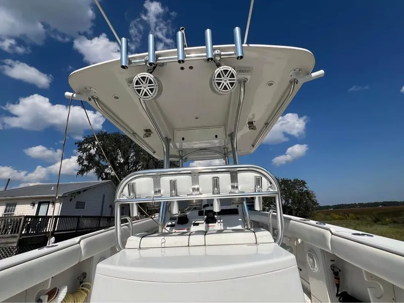 Slide: The Image of 2013 Jupiter 30 FS boat with T-top and rod holders under a clear blue sky. - 13