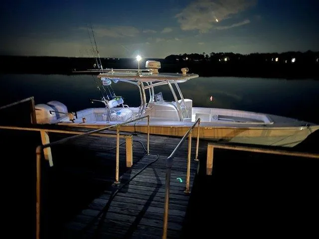 Slide: The Image of 2013 Jupiter 30 FS boat docked at night, illuminated by soft lighting. - 18