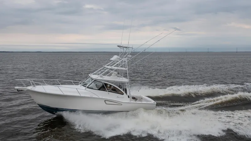 Slide: The Image of 2025 Albemarle 36 Express boat cruising on open water under cloudy skies. - 13