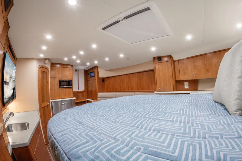 Slide: The Image of Luxurious interior of 2025 Albemarle 36 Express yacht with modern amenities and cozy bedding. - 9