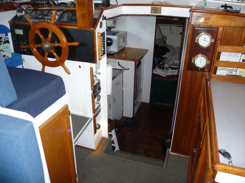 Slide: The Image of 1956 Monk 33 Sedan Cruiser interior with wooden helm, gauges, and cozy cabin space. - 19