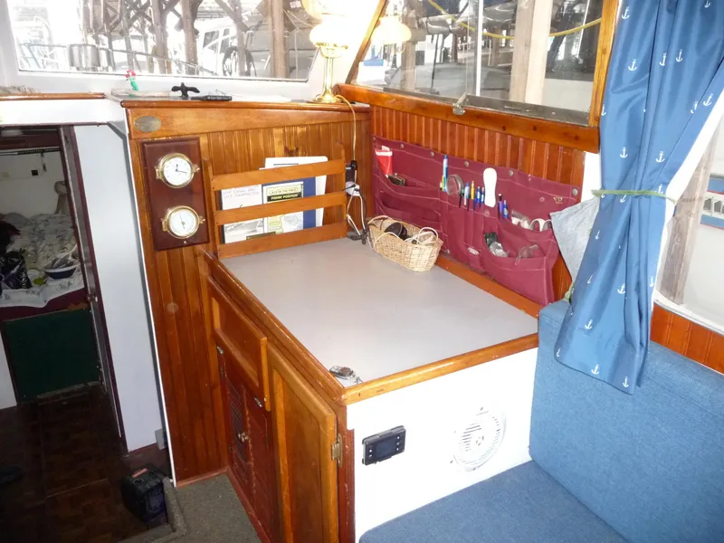 Slide: The Image of 1956 Monk 33 Sedan Cruiser interior with wooden cabinetry and nautical decor. - 20