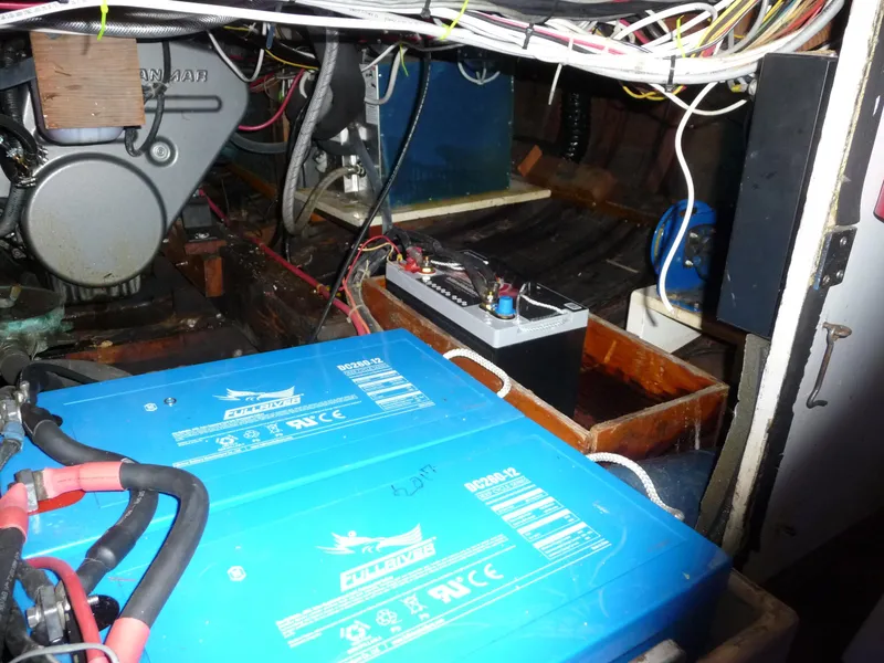 Slide: The Image of Engine room of a 1956 Monk 33 Sedan Cruiser with visible batteries and wiring. - 22