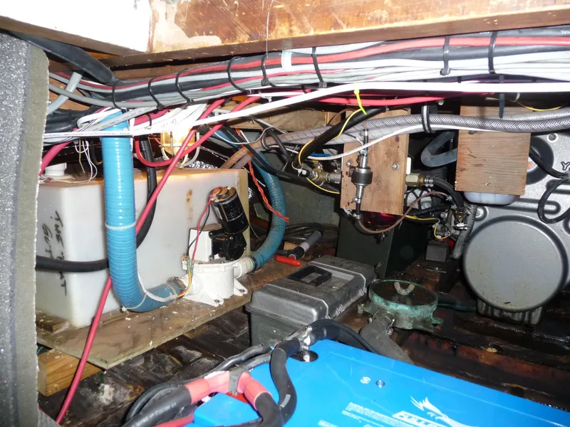 Slide: The Image of Engine room of a 1956 Monk 33 Sedan Cruiser with wiring and mechanical components. - 23