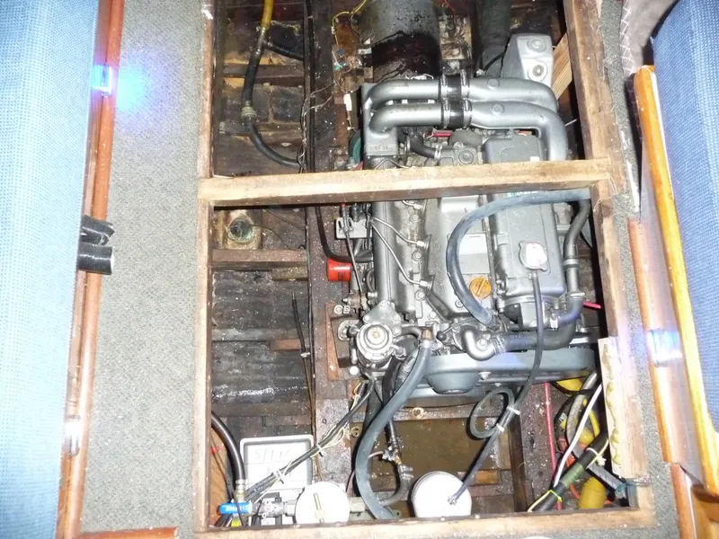Slide: The Image of Engine compartment of a 1956 Monk 33 Sedan Cruiser, showcasing mechanical components and wiring. - 24