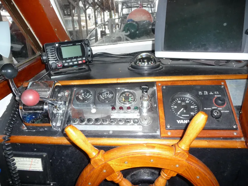 Slide: The Image of 1956 Monk 33 Sedan Cruiser dashboard with wooden steering wheel and navigation instruments. - 25
