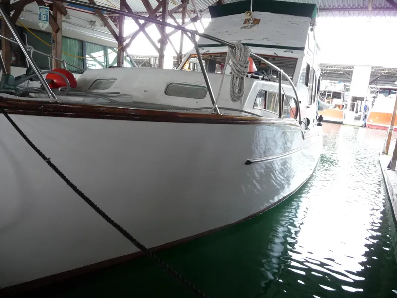 Slide: The Image of 1956 Monk 33 Sedan Cruiser docked in a marina, showcasing classic design. - 3