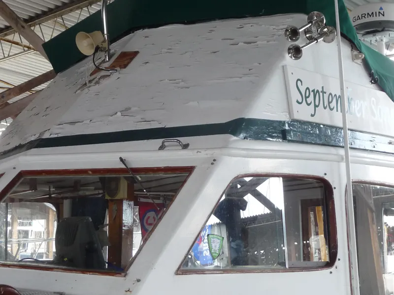 Slide: The Image of 1956 Monk 33 Sedan Cruiser in a boathouse, showing cabin details and nameplate. - 4