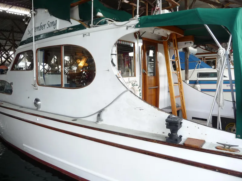 Slide: The Image of 1956 Monk 33 Sedan Cruiser docked, featuring classic design and wooden accents. - 5