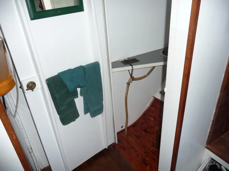 Slide: The Image of Interior of 1956 Monk 33 Sedan Cruiser showing bathroom with towels and wooden flooring. - 9