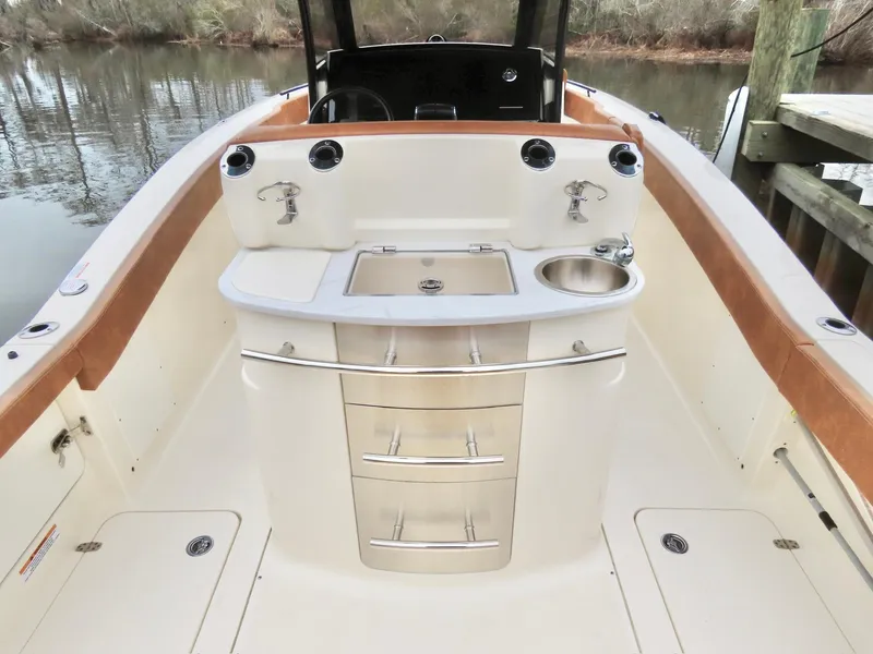 Slide: The Image of 2023 Scout 277 LXF boat interior with storage drawers and sink. - 11