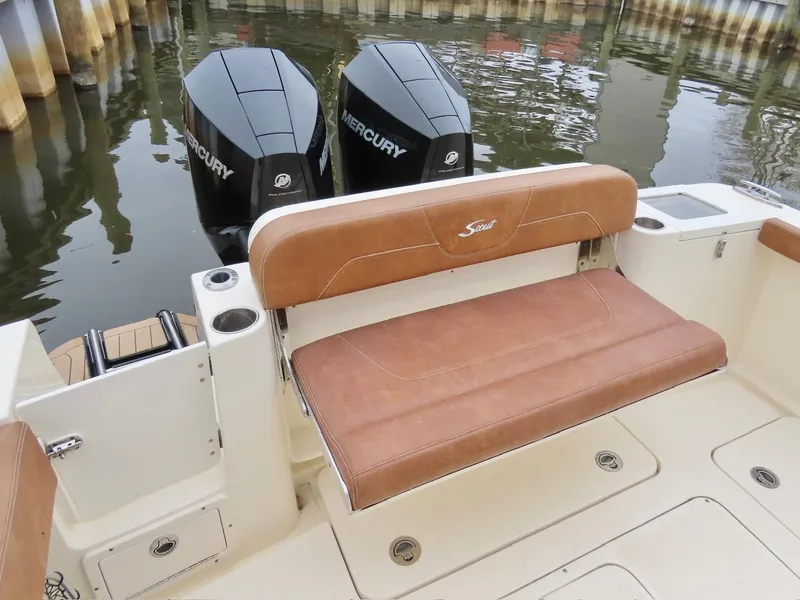 Slide: The Image of 2023 Scout 277 LXF boat with dual Mercury engines and tan seating. - 12