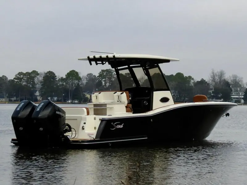 Slide: The Image of 2023 Scout 277 LXF boat with dual engines on a calm lake. - 8