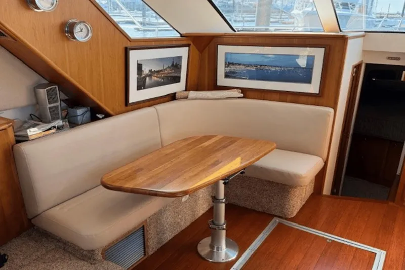 Slide: The Image of Interior of 2001 Silverton 392 Motoryacht with cozy seating and wooden table. - 14