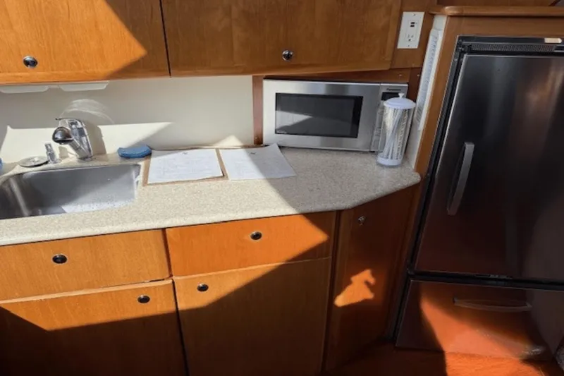 Slide: The Image of 2001 Silverton 392 Motoryacht kitchen with sink, microwave, and refrigerator. - 20