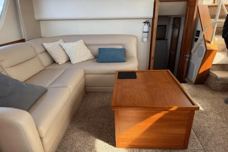 Slide: The Image of Interior of 2001 Silverton 392 Motoryacht with beige seating and wooden table. - 22