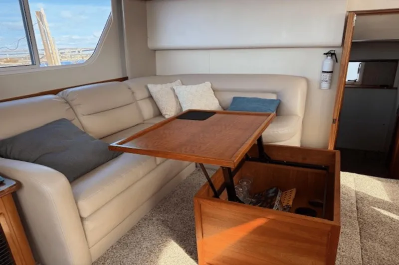 Slide: The Image of Interior of 2001 Silverton 392 Motoryacht with beige sofa and wooden table. - 23