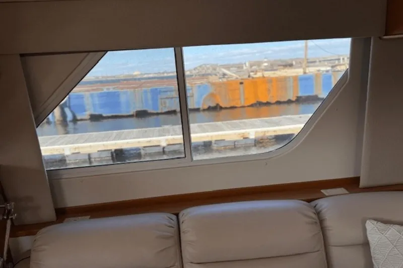 Slide: The Image of Interior view from 2001 Silverton 392 Motoryacht, showcasing window and dockside scenery. - 24