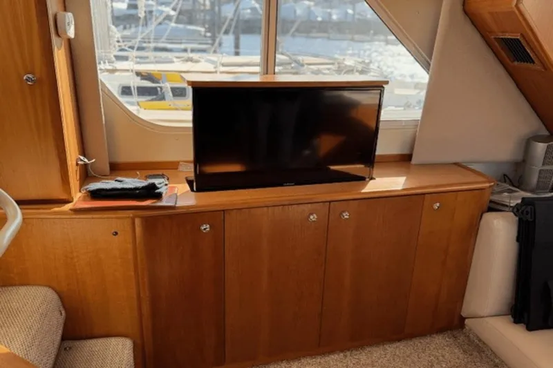 Slide: The Image of Interior of 2001 Silverton 392 Motoryacht with TV and wooden cabinetry. - 25