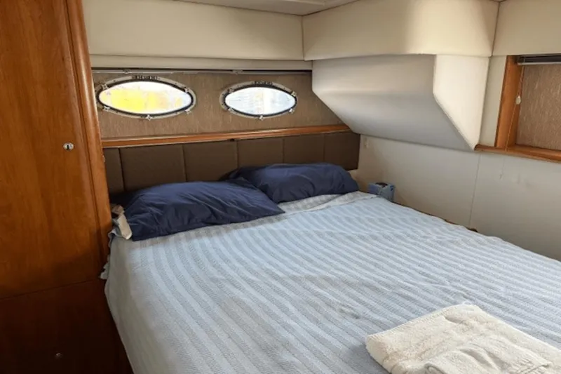 Slide: The Image of Interior cabin of 2001 Silverton 392 Motoryacht with bed and porthole windows. - 36