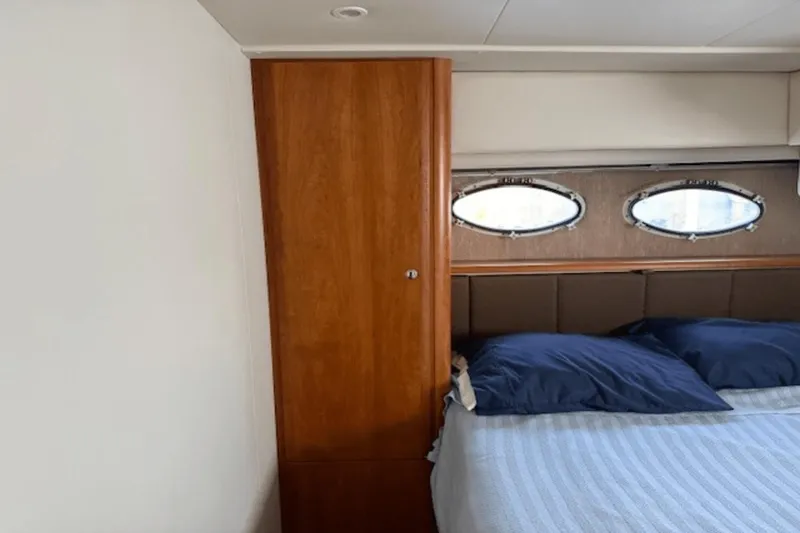 Slide: The Image of Interior cabin of 2001 Silverton 392 Motoryacht with bed and porthole windows. - 37