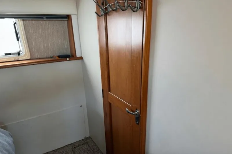 Slide: The Image of Interior of 2001 Silverton 392 Motoryacht with wooden door and window. - 39