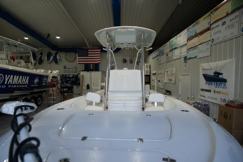 Slide: The Image of 2025 Contender 26 Bay boat in showroom, featuring sleek design and modern amenities. - 13