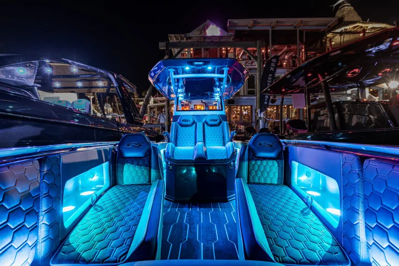 Slide: The Image of 2025 Glasstream 32 LS GSX boat interior with vibrant blue LED lighting at night. - 10