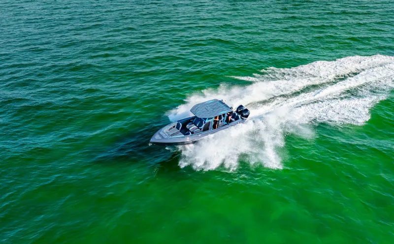 Slide: The Image of 2025 Glasstream 32 LS GSX speedboat cruising on vibrant green water. - 4