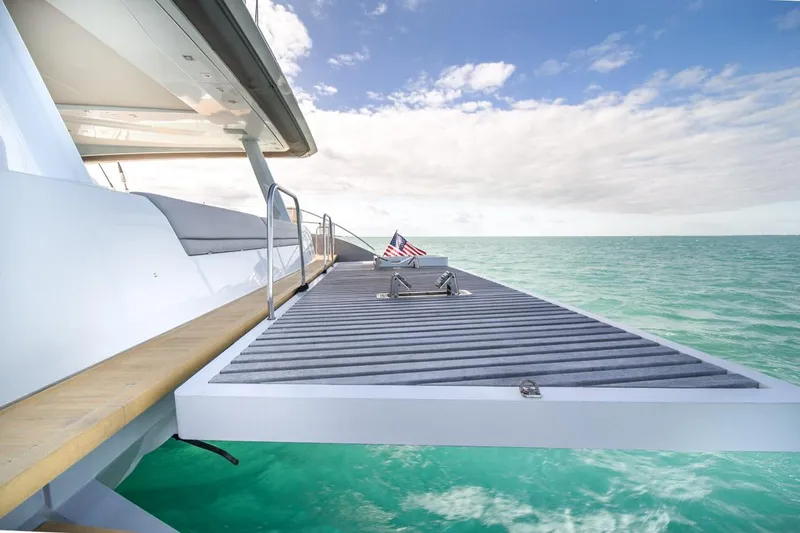 Slide: The Image of Lagoon SEVENTY 7 yacht deck extending over turquoise ocean, 2020 model. - 11