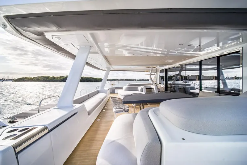 Slide: The Image of Luxurious 2020 Lagoon SEVENTY 7 yacht deck with modern seating and ocean view. - 17
