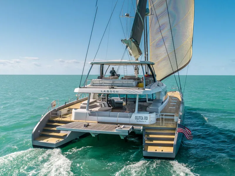 Slide: The Image of 2020 Lagoon SEVENTY 7 catamaran sailing on turquoise ocean waters. - 2