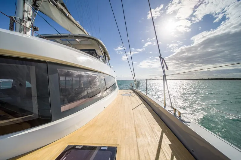 Slide: The Image of Luxurious 2020 Lagoon SEVENTY 7 yacht sailing under a bright sunlit sky. - 29