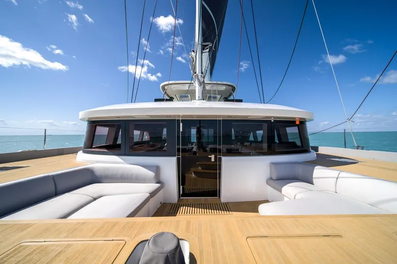Slide: The Image of Luxurious 2020 Lagoon SEVENTY 7 yacht deck with seating, under clear blue skies. - 35