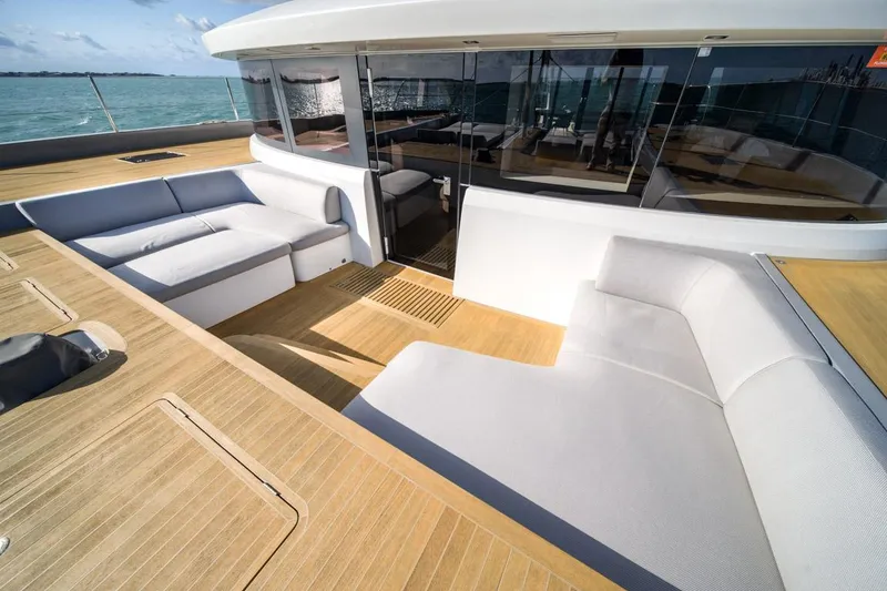 Slide: The Image of Luxurious Lagoon SEVENTY 7 yacht deck with modern seating, 2020 model, on open water. - 36