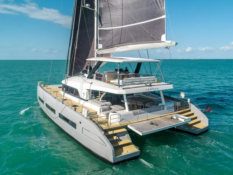 Slide: The Image of 2020 Lagoon SEVENTY 7 catamaran sailing on turquoise ocean waters. - 4