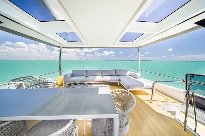 Slide: The Image of Luxurious Lagoon SEVENTY 7 yacht deck with ocean view, modern seating, and dining area, 2020 model. - 41