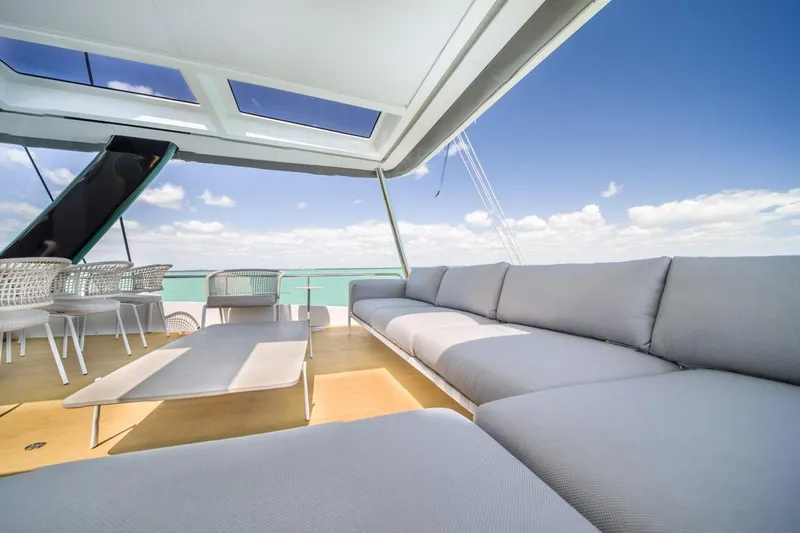 Slide: The Image of Luxurious Lagoon SEVENTY 7 yacht deck with modern seating, ocean view, and clear skies. - 43