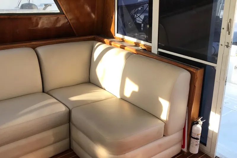Slide: The Image of 1991 Tiara Yachts Fly Bridge interior with beige seating and wooden accents. - 30