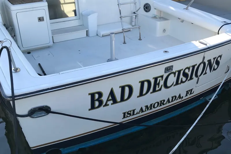 Slide: The Image of 1991 Tiara Yachts Fly Bridge with "Bad Decisions" name, docked in Islamorada, FL. - 43