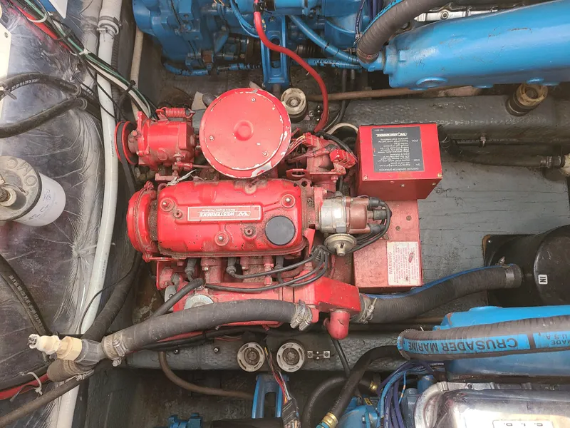 Slide: The Image of Engine compartment of a 1992 Four Winns Express Cruiser with red and blue components. - 21
