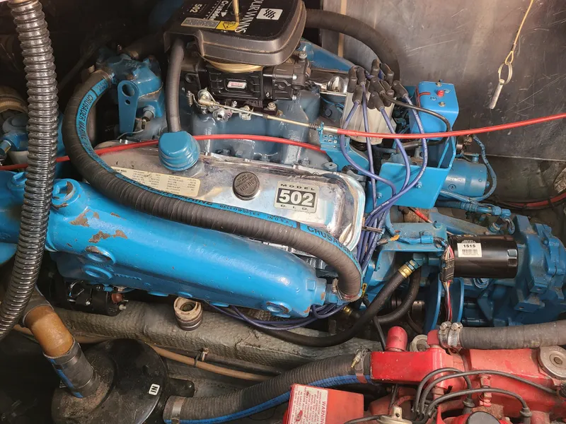 Slide: The Image of Engine of a 1992 Four Winns Express Cruiser, featuring a blue 502 engine. - 22