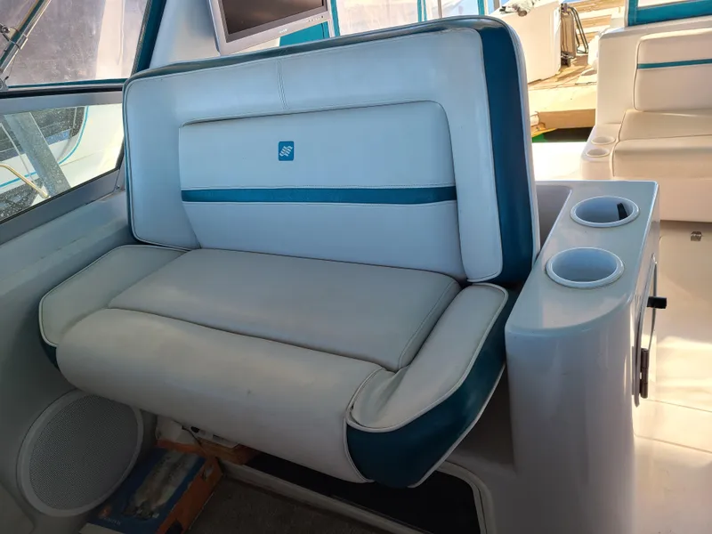 Slide: The Image of 1992 Four Winns Express Cruiser interior seating with cup holders and speaker. - 9
