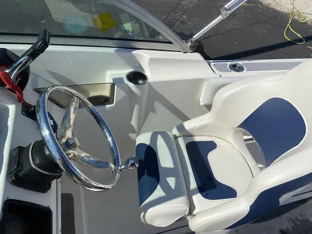 Slide: The Image of Interior of a 2012 Pioneer 197 Venture boat with steering wheel and seat. - 12